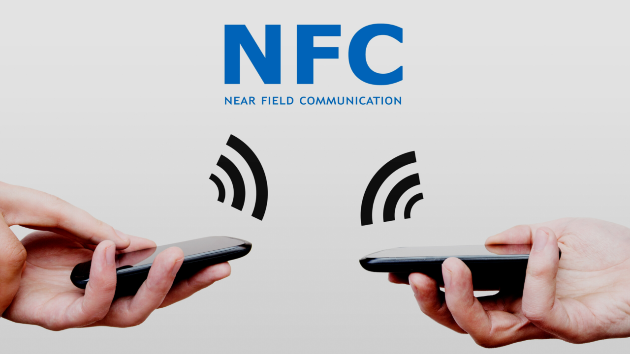  Two hands holding smartphones with the NFC logo between them.